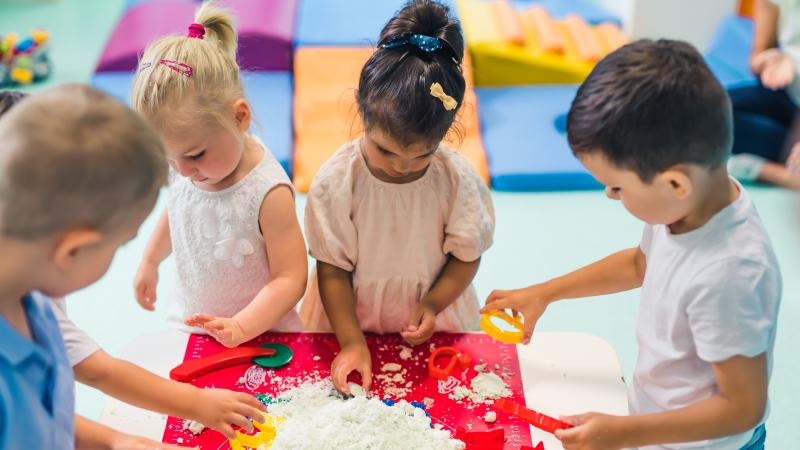 toddlers playing at sensory table 